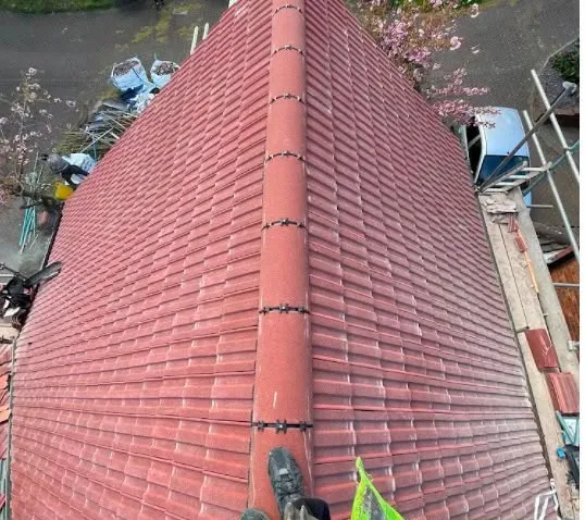 Red tiled roof with a mechanically fixed dry ridge