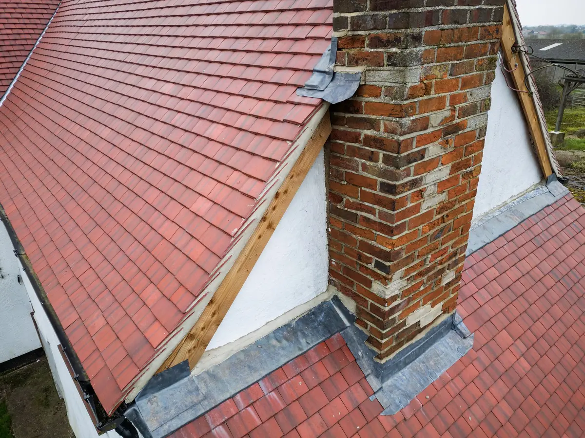 Brick chimney stack with lead flashings