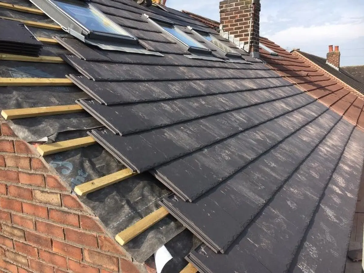 Slate roof being laid around roof windows