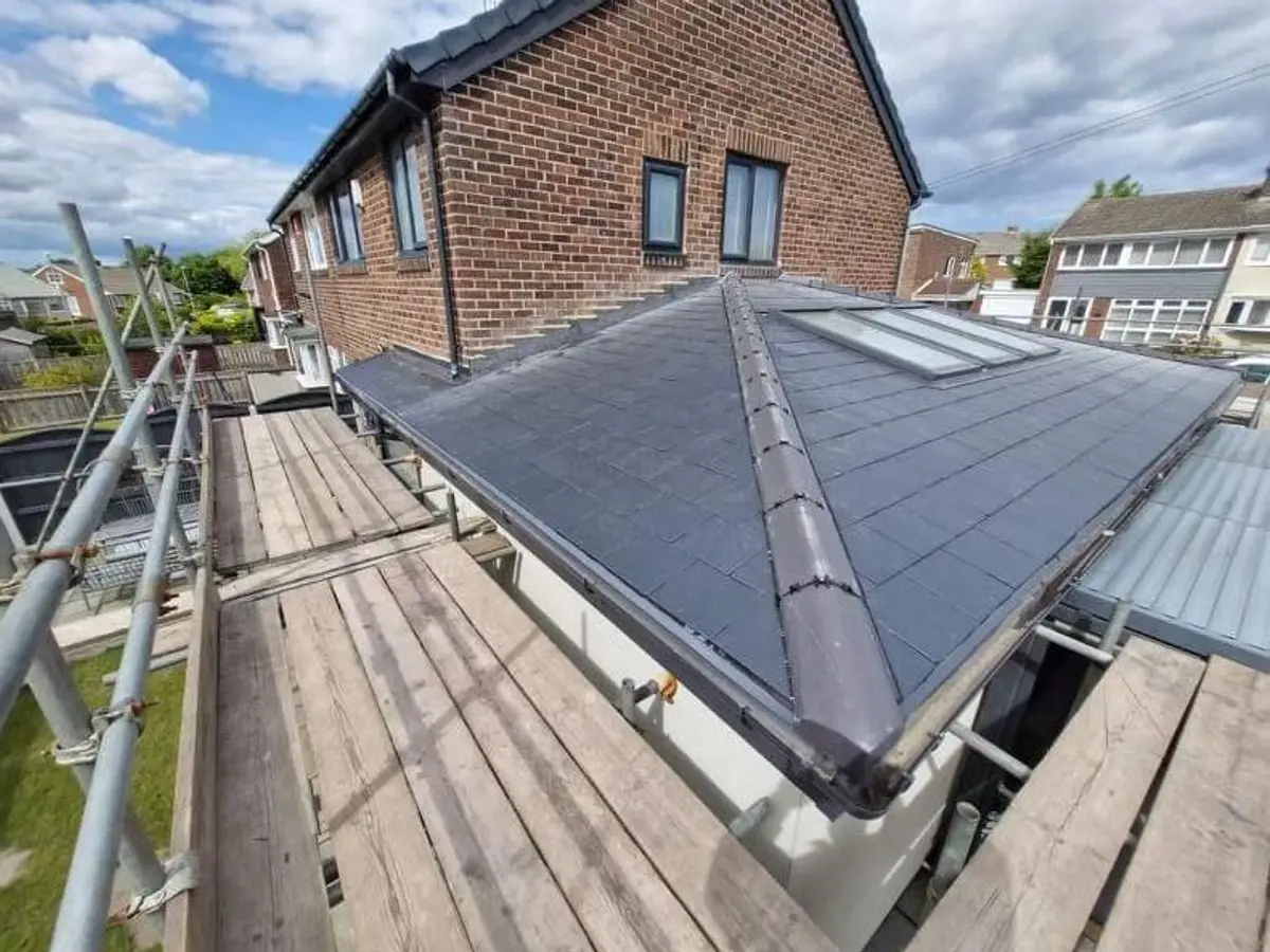 Hip roof finished with a dry fix ridge system