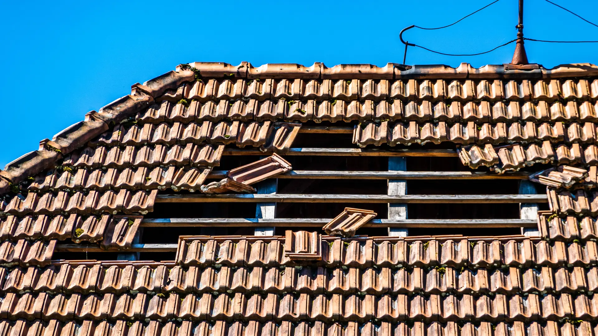 Storm damaged roof with missing tiles