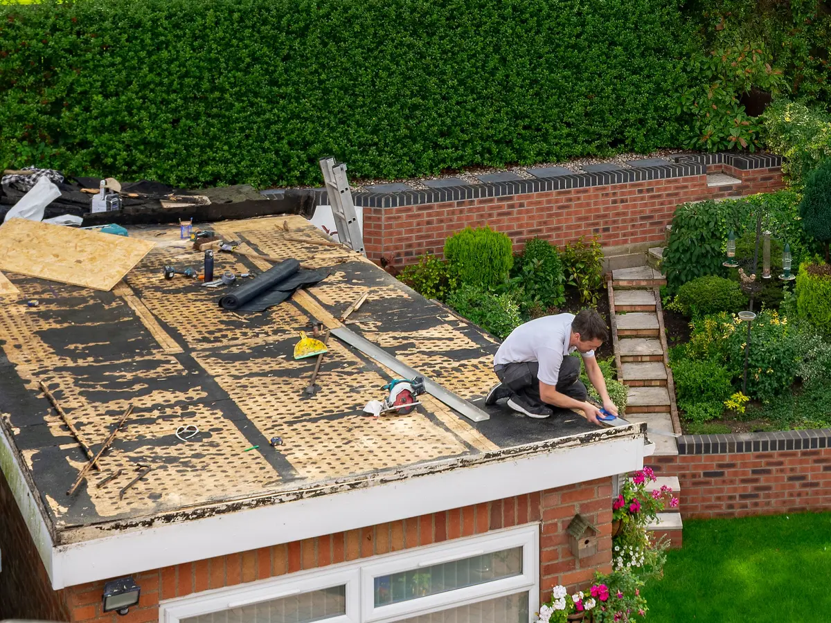 Roofer working on a garage flat roof